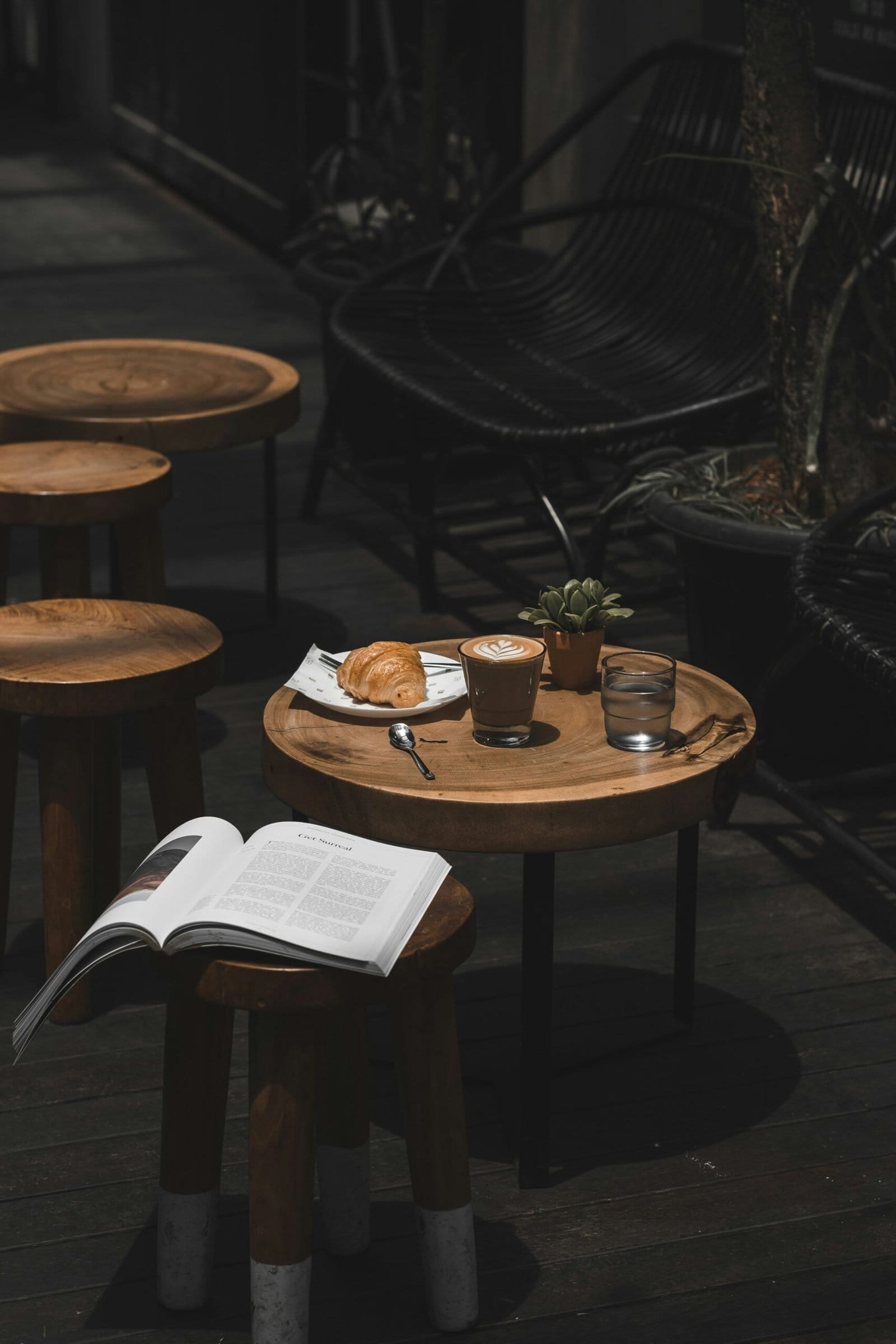 two clear drinking glasses on top of brown wooden table