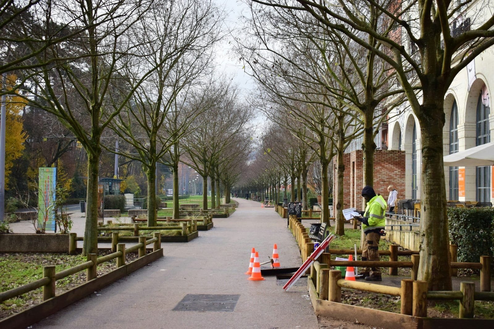 a man in a green jacket is working on a park